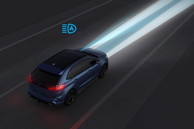 An animated view of Edge driving on a dark road with Auto High Beams on