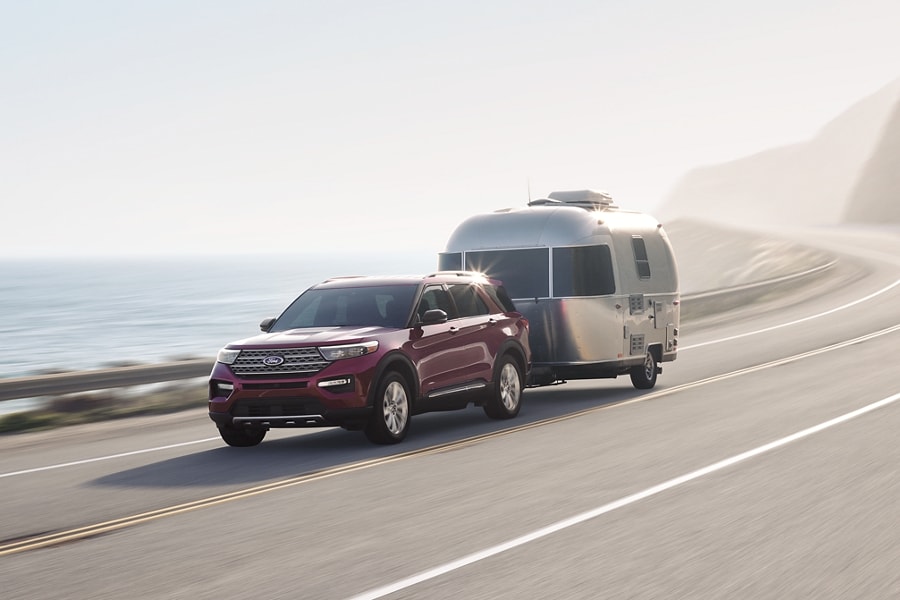 2023 Ford Explorer® SUV pulling a camper down a highway