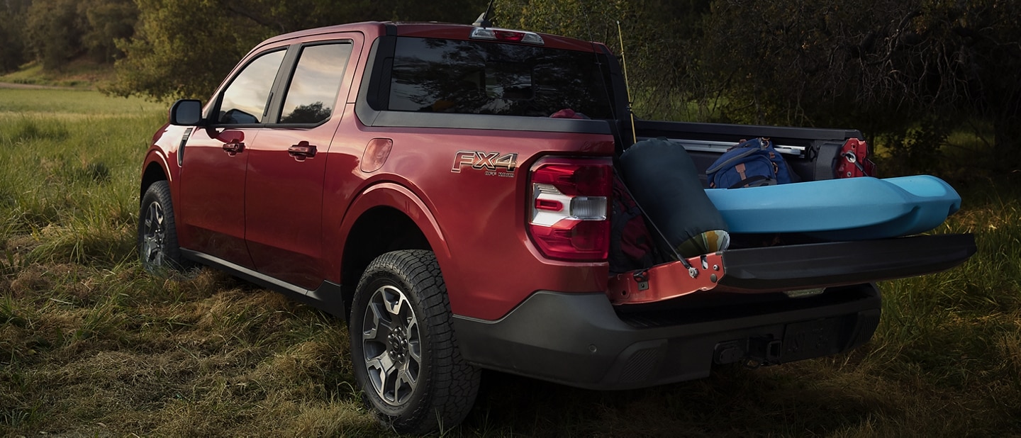 2023 Ford Maverick® truck parked with multi-position tailgate open to accommodate camping gear
