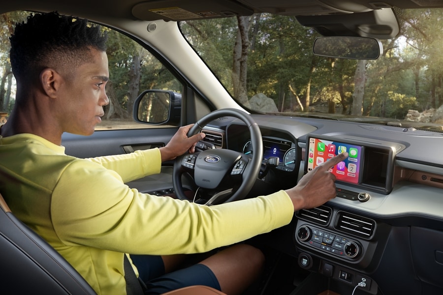 A person is engaged with Apple CarPlay® inside a 2024 Ford Maverick® truck