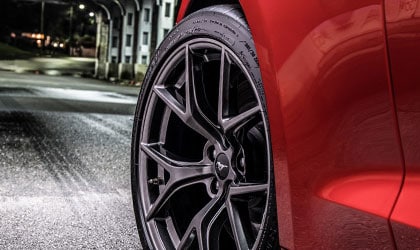 Close up on front wheel of 2020 Ford Mustang in Race Red