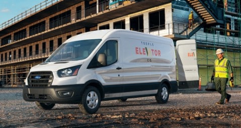 Construction workers near 2020 Ford Transit in White Platinum with open rear doors at work site