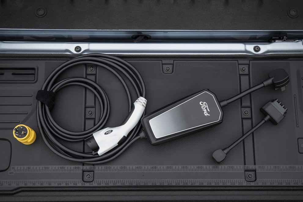 A Ford Mobile Power Cord stored in the back of an F-150® Lightning®